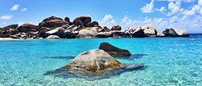 A picture of crystal blue waters and rocks