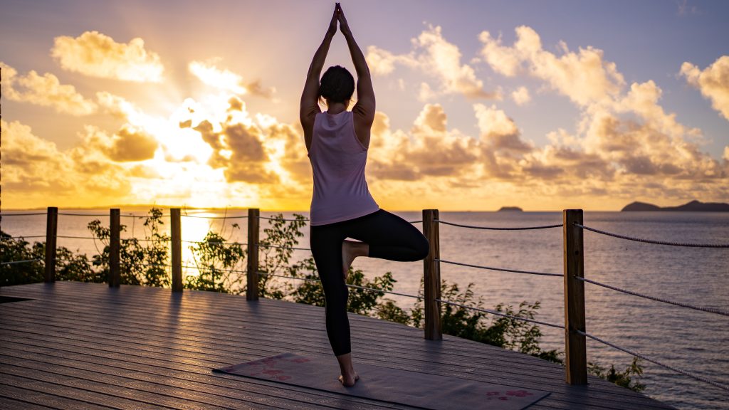A picture containing outdoor, sky, cloud, person doing yoga at Ixora Spa at Scrub Island Resort Spa & Marina in the British Virgin Islands