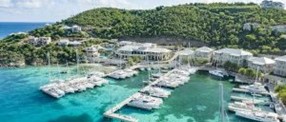 A marina with boats and buildings in the water at Scrub Island Resort Spa & Marina in the British Virgin Islands