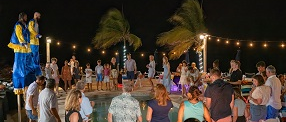 people around pool at night for a hotel event