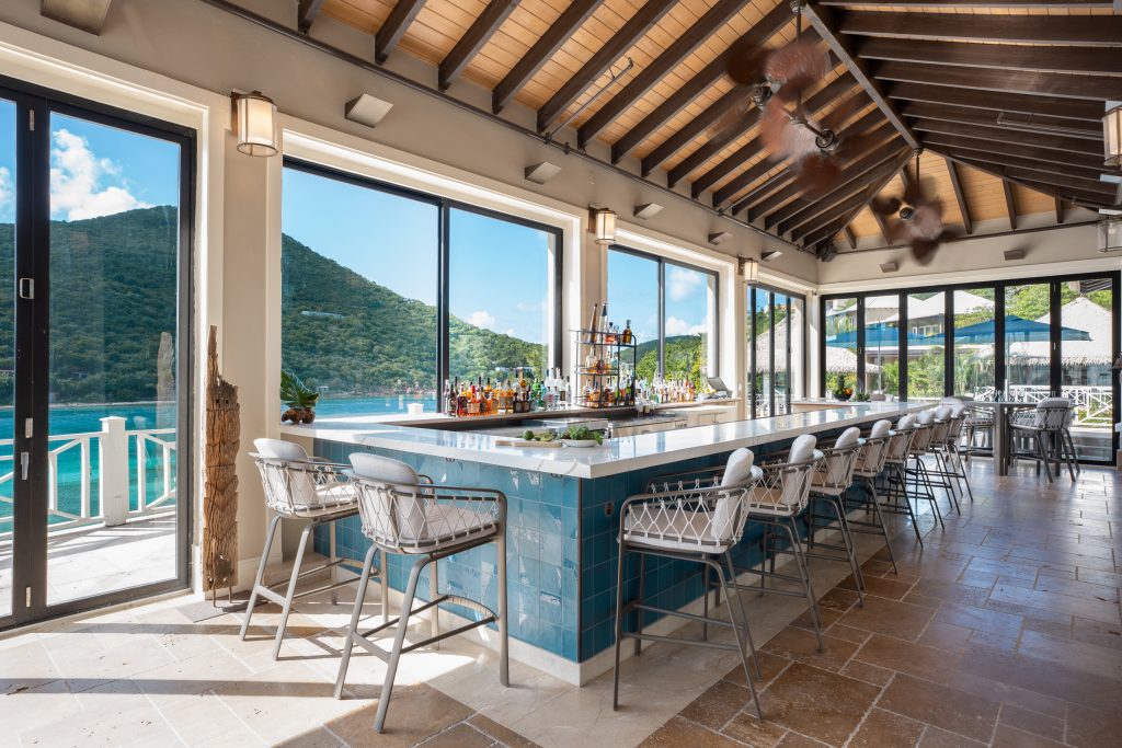 an image of a restaurant bar with bar stools on a caribbean island