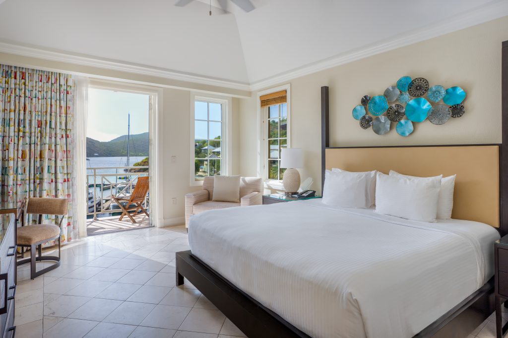 a hotel bedroom overlooking a marina on private Scrub Island in the BVI