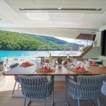 a aftdeck dining and lounge area on a private charter sailing catamaran in the Caribbean