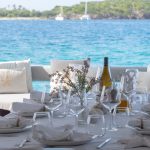 a dining table set for lunch aftdeck on a sailing catamaran in the Caribbean