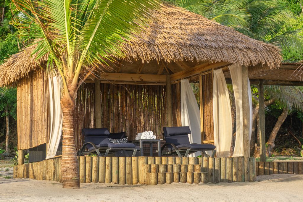 a cabana with two loungers on a Caribbean island