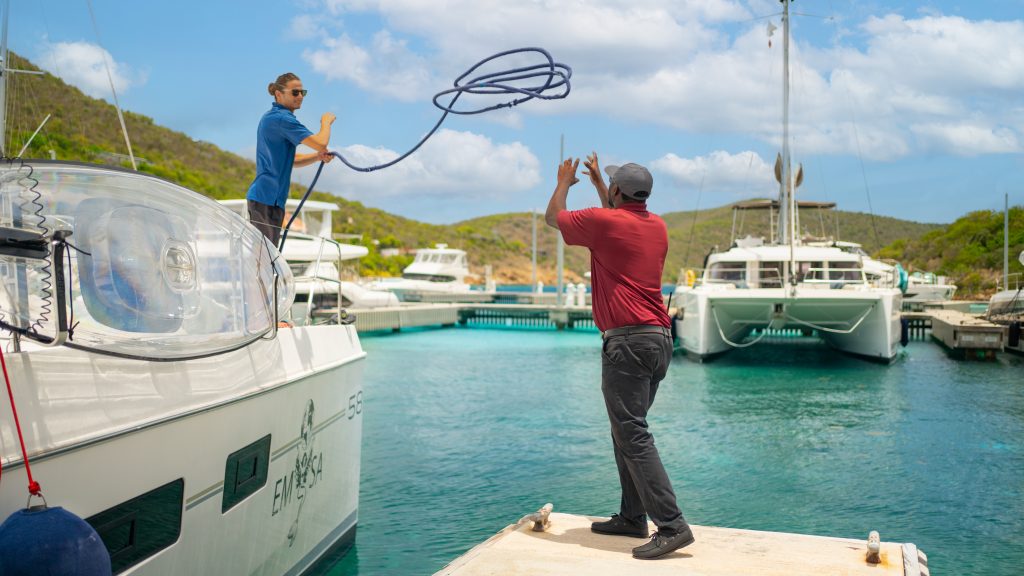 Staff assist a yacht docking at Scrub Island Resort, Spa & Marina in the BVI
